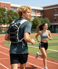All Day Hydration Vest With Water Reservoir For Trail Ready Rides On The Go And Runs worn by a man jogging on a track