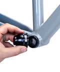 Hand holding Blue Bottom Bracket And Pedal Tool For Pro Grade Bike Maintenance, 16 Notch Socket Fits Shimano XTR BB93 installation.