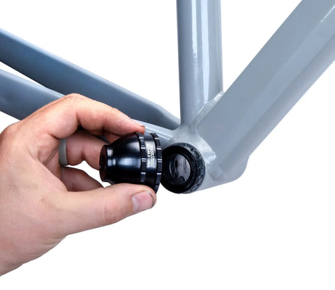 Hand holding Blue Bottom Bracket And Pedal Tool For Pro Grade Bike Maintenance, 16 Notch Socket Fits Shimano XTR BB93 installation.
