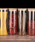 Heavy Glass Coffee Canister 2200Ml Wide Mouth Airtight Food Storage Jar For Tea Sugar Beans And Nuts Gonna Keep Your Morning Brew Fresh Along Your Counter filled with pasta, dried chili, and spices.