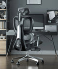 Black ergonomic office chair with footrest for long hours, adjustable lumbar support, and mesh back in home office setting.
