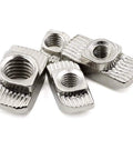 Close-up of nickel-plated M8 T slot nuts hammer head fasteners for 4040 aluminum profiles, rust-resistant heavy-duty hardware.