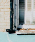 Tough As Nails Shutter Tilt Rod Staples Heavy Gauge Steel Window Repair Hardware Kit installed on weathered window frame.