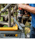 Brushless Cordless Hammer Drill With Two 20 Volt Batteries And Active Hammer Action For Concrete Masonry And Wood That Straight Up Crushes Every DIY Job And Handles Tough Home Projects Like A Boss drilling into metal guide with a hand on the drill.