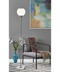 Fiona Torchiere Floor Lamp In Brushed Steel With Marble Base And Opal Glass Shade in modern living room setting
