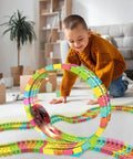 Child playing with Twister Tracks 360 Loop Neon Glow In The Dark Track Set With 13 Feet Of Flexible And Loop Track And One LED Light-Up Race Car