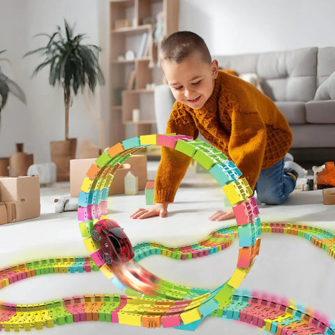 Child playing with Twister Tracks 360 Loop Neon Glow In The Dark Track Set With 13 Feet Of Flexible And Loop Track And One LED Light-Up Race Car