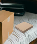 Corrugated Paper Dividers And Protective Base Insert Pads For Moving Boxes 12 Pack resting on bed with cardboard box nearby