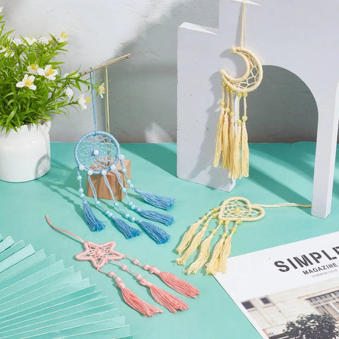 DIY Dream Catcher Kit For Beginners 24 Piece Colorful Mini Ornament Set with star, moon, heart shapes on blue surface