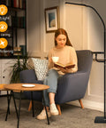 Smart LED Floor Lamp With Wireless Charger, 12W Dimmable Standing Lamp next to woman reading in living room chair