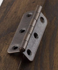 Close-up of 3 Inch Antique Copper Iron Round Corner Hinges For Cabinet Doors Built Tough Open 270 Degree Furniture Hinge on wood