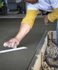 Worker using PermaShape Finishing Trowel 12 X 5 Inch with DuraSoft Handle on concrete slab
