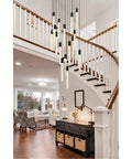 Modern 16 Light Ceiling Pendant With Heavy Duty Black Metal Frame And Crisp Crystal Drops For A Straight Up Room Makeover And A Seriously Lit Ambient Vibe hanging over a dark console table in a bright entryway.