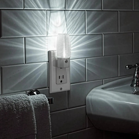 Plug In LED Night Light With Dusk To Dawn Sensor, 5000K Daylight in a bathroom setting, illuminating white tiled wall.