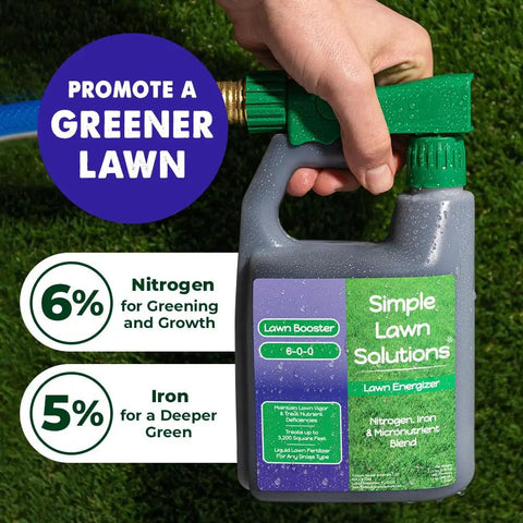 Hand holding hose end sprayer with bottle of Heavy Duty Liquid Lawn Fertilizer With Iron And Nitrogen, Lawn Energizer Booster, 32 Ounce