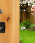 Top Shelf Spring Loaded Gate Latch Cable Pull Kit attached to wooden fence, hand holding the cable pull for easy use.