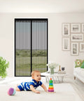Living room with a Magnetic Screen Door For Doors Up To 37 By 82 Inches, Self Sealing Mesh Magnetic Closure, black, with a baby playing.