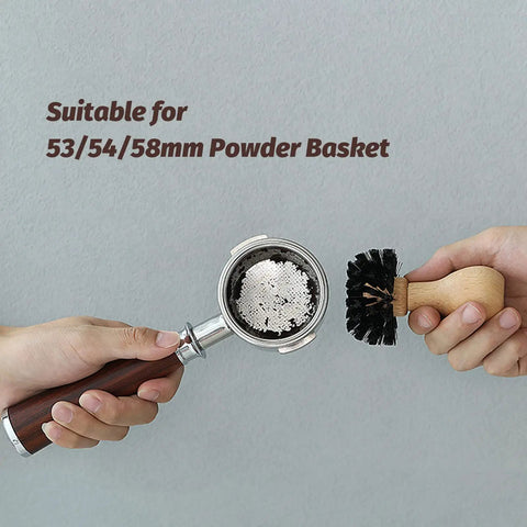 Hands holding 58mm Portafilter Cleaning Brush For Espresso Machines Pro Barista Tool With Arc Bristle Design.