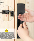 Top Shelf Thumb Press Gate Latch With Slick Grip Handle Rock Solid Black Metal Yard Lock close up installation view on wooden door.