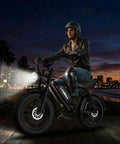 Rider on Beast 2000W Electric Fat Tire Bike For Adults With Top Speed 36 MPH, city skyline backdrop at night