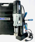 Knockout Performance Heavy Duty Magnetic Drill Press Built Like A Tank For Real Contractors With Two Speed Settings Three Inch Capacity And 1850 Watt Muscle For Any Metal Project next to its black carrying case on a white background.