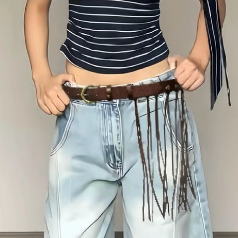 Dope Fringe Belt With Antique Bronze Buckle And Adjustable Waist Strap For Vintage Industrial Vibes And Edgy Streetwear Fits Dynamic Tassel Design Casual Accessory worn with light blue jeans.