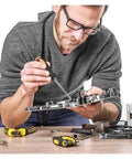 Man using screwdriver from All-In-One 108-Piece Socket Wrench Auto Repair Tool Set With Heavy-Duty Hand Tools And Storage Case on circuit board.
