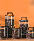 Premium Glass Coffee Canister With An Airtight Wooden Lid To Keep Your Daily Grind Fresh Kitchen Counter Storage Jars filled with coffee beans.