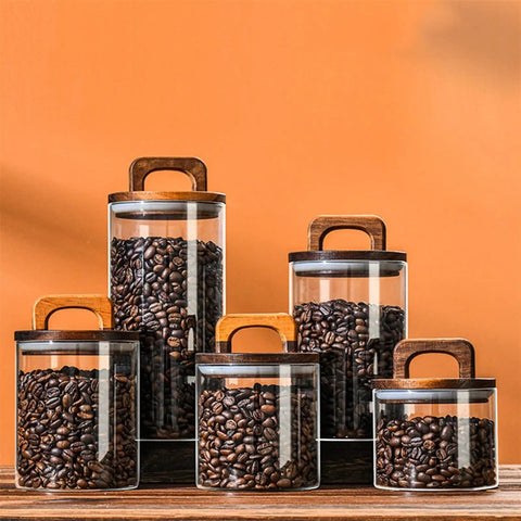 Premium Glass Coffee Canister With An Airtight Wooden Lid To Keep Your Daily Grind Fresh Kitchen Counter Storage Jars filled with coffee beans.