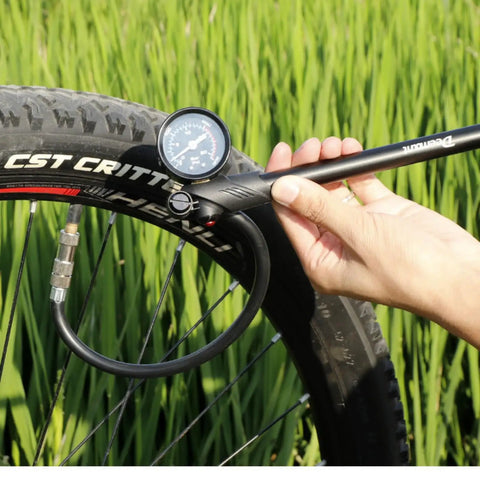 Using Shock Pump for Road and Mountain Bikes High Pressure 300 PSI Gauge to inflate bike tire, showing Schrader valve connection.