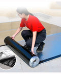 Heavy Duty Bitumen Sealing Tape With Reflective Aluminum Foil Backing being unrolled for roof repairs by a user.