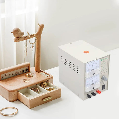 3A Electroplating Machine For Jewelry, 110V Pro Grade Gold And Silver Plating Power Supply With Real Time Voltage Meters on workspace with jewelry organizer.