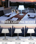 Solar Powered Outdoor Table Lamp With 3 Way Dimmable LED on patio dining table at sunset, showcasing three lighting modes.