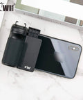 Compact Phone Camera Grip Handle With Tripod Mount Remote Shutter And Cold Shoe Adapter attached to smartphone on marble surface