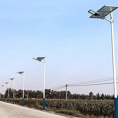 Tough As Nails Outdoor Solar Flood Lights With Smart Motion Sensor illuminating a driveway with sleek design and white poles.