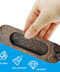 Hand holding Two Pack 4.13 Inch European Recessed Flush Pull Handle in Antique Copper Finish for sliding doors with labels zinc alloy, anti-corrosion, and hardness.