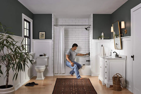 Person adjusting Elmhurst Shower Trim Kit For Shower Only Without Tub Spout Oil Rubbed Bronze Finish in modern bathroom setting