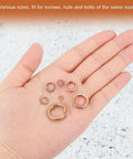 Hand holding various sizes of 20 Pack Copper Spring Lock Washers M8 Split Lock Washers For Screws Bolts Nuts Inner 8.1 To 8.7 Mm Outer 12.1 To 13.1 Mm Thick 2 To 2.2 Mm With Pickling Finish No Slip Built Tough For Auto DIY Projects.