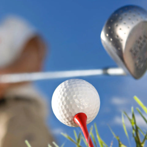 Close-up of a golf ball on a Two And Three Quarter Inch Red Wood Golf Tees Pack Of 100 Built For Real Players With Pro Grade Performance