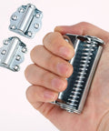 Solid As A Rock Self Closing Door Hinges 3 Piece Set in hand, showing zinc springs and hinge design for kitchen cabinets.
