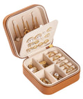 Super Chic Travel Jewelry Box With Waterproof PU Leather Exterior And Soft Flannel Interior Removable Dividers holding rings, earrings, and necklaces.