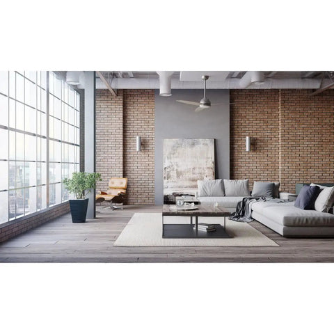 6 Inch Cylinder Outdoor Wall Sconce Two Light Up And Down Slick Modern Exterior And Interior Lighting Aluminum Construction Metallic Gray For Porch Patio Deck Weather Resistant against a brick wall in a modern living room.