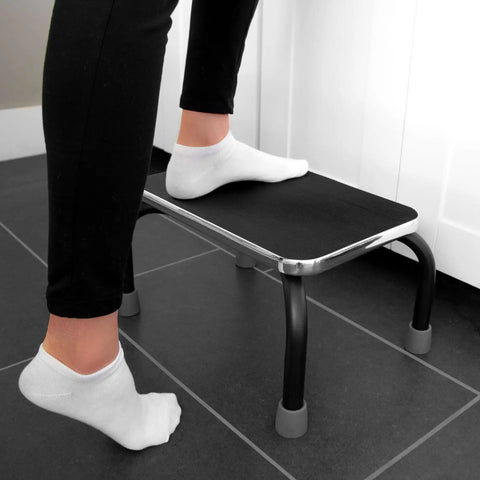 Person using heavy duty metal step stool for adults and seniors portable non slip foot stool with 250 lb capacity pre assembled