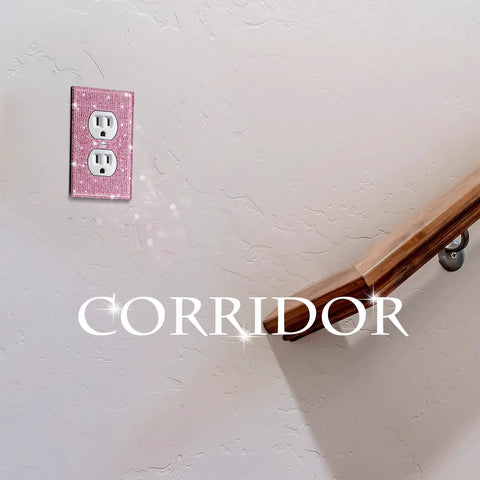 Pink Rhinestone Light Switch Covers Set of 4 Sparkly Wall Plate Covers on a corridor wall next to a wooden railing.