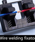 Heavy Duty Wire Welding Holder Clamp With High Temp Resistant ABS Base To Securely Grip Loose Cables For Soldering Home DIY Projects And Workshop Repairs Like A Pro, showing two wires held in place.