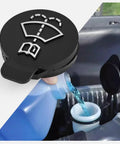 Black washer fluid reservoir cap being installed on a vehicle; Windshield Washer Fluid Reservoir Cap for GM Rides and Trucks Fits Cadillac Escalade Chevrolet Silverado Malibu Impala GMC Sierra 1500 Buick Enclave Acadia and More