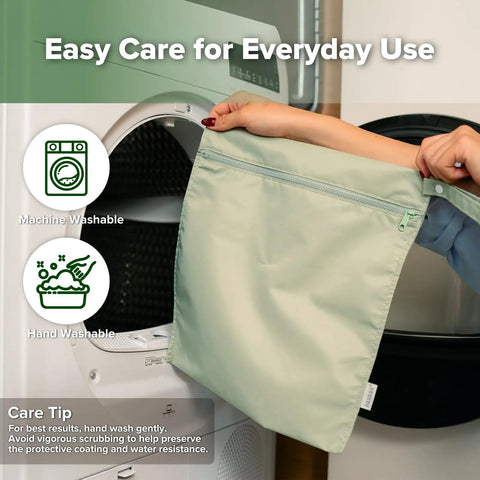 Person placing a grass green wet bag in a washing machine, highlighting the Waterproof Wet Bag Set For Baby On The Go.