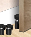 Magnetic Door Stopper And Holder For Secure Doors Under Two And A Half Inches Heavy Duty Stainless Steel Anti Rust Stops Slams And Keeps Doors From Slamming Steady And Reliable For Home And Office Black Finish 1 Pack installed on floor.