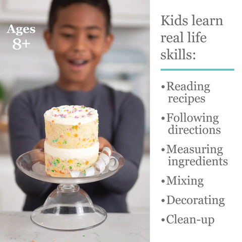 Child holding a decorated cake with the Playful Chef Kids Cake Decorating Kit With Pans Reusable Pastry Bags and Recipes.