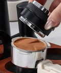 Top Shelf Espresso Setup 51mm Spring Loaded Tamper Set with black tamper over coffee grounds in metal portafilter.